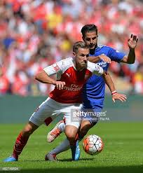 Fabregas challenging Arsenal's Aaron Ramsey